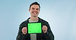 Tablet, green screen and face of man in studio happy with mockup, offer or promo info on blue background. Digital, presentation and portrait of guy model show app, step or sign up platform or service
