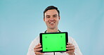 Doctor, man and tablet green screen in clinic presentation, website or medical advice in studio. Face of healthcare worker speaking on digital mockup, telehealth or tracking marker on blue background