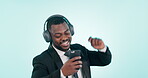 Business, phone and black man dance to music, celebration and energy. Happy professional moving with smartphone, headphones and listening to radio in studio isolated on blue background mockup space