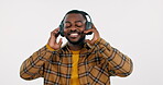 Dancing, smile and black man with headphones, music or celebration on a white studio background. African person, guy or model with headset, energy or movement with happiness, streaming audio or sound