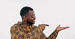 Pointing to mockup, happy or black man in studio by discount deal or sale on menu for advertising. Space, face or African person showing choice for guide option, news or offer on white background 