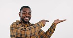 Pointing to mockup, face or black man in studio by discount deal or sale on menu for advertising. Space, happy or African person showing choice for guide option, promo or offer on white background 