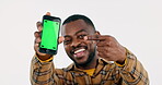 Face of black man, pointing or phone green screen for social media advertising or online branding. White background, show or happy person with smile, mobile app chroma key or mockup space in studio