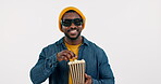 3d glasses, black man eating popcorn in cinema and watching movie in studio isolated on a white background mockup space. Food, theater and happy African person streaming film, show and television