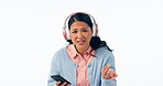 Phone, music and question with a confused asian woman isolated on white background in studio to ask what. Portrait, doubt and young person looking annoyed while listening to sound or streaming audio