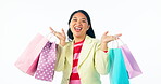 Woman, winner and shopping bag celebration, dance and happy for discount, sale or retail giveaway in studio. Face, customer or excited asian person with gift in commerce or retail on white background