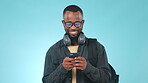 Phone, man and happiness in studio for social media, funny meme or text message in studio on blue background. Smartphone, person and smile for internet gif, website search or online post with mockup