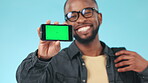 Smartphone, green screen and black man with advertising mockup, app design and ads isolated on blue background. Tracking marker, social media and information on website, marketing and blog in studio