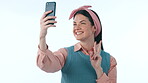 Happy, social media and peace sign selfie with a woman in studio on blue background for a profile picture. Phone, smile and photo with a young influencer or content creator posing for a status update