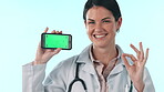 Green screen cellphone, happy woman and doctor okay, point and show medical web promo, mockup space or hospital app. Smartphone tracking markers, portrait and nurse ok agreement on studio background