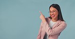 Happy, face and business woman with hand pointing in studio for presentation on blue background. Portrait, smile and female entrepreneur show checklist, vote or deal, promotion or contact us platform