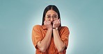 Anxiety, fear and face of woman biting nails in studio for news, feedback or review on blue background. Stress, panic and portrait of nervous female model with wrong choice, mistake or decision doubt