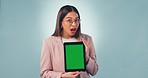 Business woman, presentation and technology with green screen, studio and blue background in mockup with tracking markers. Female, person or worker with announcement, discount or offer on promotion