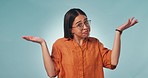 Confused, face and woman in studio with why hands for choice, dont know or asking on blue background. Doubt, portrait and lady model show palm scale solution, balance or questions, emoji or how to