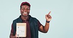 Courier man, boxes and point in studio with face, smile or mockup space for supply chain by blue background. African delivery guy, cardboard package or icon for choice, logistics or emoji for review