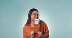 Woman, smile and dancing with plane ticket in hands, trip and holiday or vacation. Excited person, travel and flight to destination, happy and goofy to getaway, studio and portrait by blue background