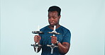 Dancing, fitness and funny black man with dumbbell for training or exercise isolated in a studio blue background. Excited, joy and athlete or person enjoy workout for health, wellness and happiness