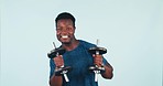 Dancing, training and funny black man with dumbbell for fitness or exercise isolated in a studio blue background. Excited, joy and athlete or person enjoy workout for health, wellness and happiness