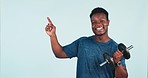 Happy black man, fitness and pointing with dumbbell for weightlifting or advertising against a studio background. Portrait of African male person showing deal or sale discount for workout or exercise