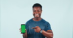 Man, pointing and portrait with green screen for mobile app in studio for fitness, training or online exercise program. Hand, gesture and athlete with phone chrome key for promotion or social media