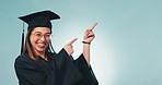 Face, graduation and woman with promotion, pointing and announcement on a blue studio background. Portrait, person and model with hand gesture, education and achievement with celebration and success