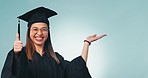 Happy woman, student and palm with thumbs up for graduation success against a studio background. Portrait of female person or graduate with hand out, like emoji or yes sign for thank you or winning