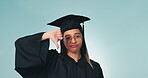 Thumbs down, graduation and student loans with a woman in studio on a blue background for education. Portrait, scholarship and debt with an unhappy university or college graduate looking upset