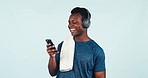 Fitness, meme and man reading with phone on blue background in studio with social media, post or online joke. Sports, athlete and person laughing with cellphone and funny communication on internet