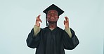 Graduation, university and education, black man with fingers crossed in studio for achievement or future career. Hope, opportunity and college student with wish, scholarship dream and blue background