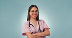 Happiness, arms crossed and studio woman, nurse or surgeon for healthcare work, job experience or clinic service. Confident, portrait and medicine expert, doctor or hospital person on blue background