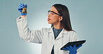 Doctor, tablet and reaction with a science woman in studio on a gray background for research or innovation. Medicine, technology and chemical biology with a young scientist working on a breakthrough