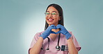 Woman, nurse and heart emoji for healthcare, wellness and trust in studio on blue background with smile. Portrait, person and professional in health with love icon for care, safety and happiness
