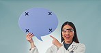 Happy scientist woman, speech bubble and studio to point, smile and face by blue background. Doctor, quote and poster for feedback, voice and opinion with tracking markers for review on social media