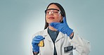 Science, woman and research by testing in studio on blue, backdrop or mockup for fragrance, smelling and cosmetics. Female, person or doctor with smile for results with thumbs up, gloves and lab coat