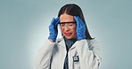 Science, doctor and woman with headache in studio on blue background with copy space for mental health, burnout or stress. Female, person and overwhelmed in pain with research, results or experiment