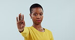 Woman, face and stop with hands, warning and caution of rejection sign in studio on white background. Portrait, african model and protest with palm for no emoji, ban or vote to fight for human rights