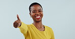 Success, smile and thank you with a black woman thumbs up in studio on a blue background for motivation. Portrait, goal and happy with a winner young person showing a like emoji to gesture yes