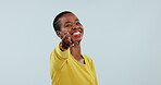 Smile, choice and pointing at you with a black woman in studio on gray background to vote or promote. Portrait, opportunity or decision and happy young person with a gesture of decision or selection