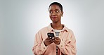 Woman, phone and texting in studio, thinking and doubt with typing, question or idea by white background. African gen z girl, smartphone and confused face for communication, web chat or social media