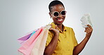 Winner, shopping bag and money with face of black woman in studio for giveaway, discount and payment. Sales, cashback and promotion with portrait of customer on white background for retail deal