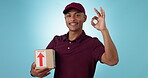 Box delivery, happy man or studio ok sign for logistics courier service, product shipping opinion or export vote agreement. Package distribution, okay emoji icon or portrait person on blue background