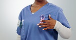 Cancer, ribbon and nurse for awareness or support in studio with pink symbol and healthcare. Medical worker person with icon on breast for care, charity or movement and recovery on a white background