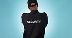 Security guard, studio and back of person for protection service, safety workforce or law enforcement. Uniform, police authority and bodyguard for justice, danger and crime patrol on blue background