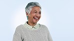 Face, wink and senior woman with a smile, agreement and facial expression on a blue studio background. Portrait, pensioner or old person with emoji, icon and model with happiness, wellness or excited