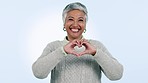 Heart, hands and face of senior business woman in studio with smile message and gratitude on blue background. Emoji, shape and portrait of elderly female ceo show thank you frame for startup support