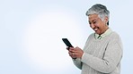 Senior woman, phone and studio by mockup space for contact, chat or funny meme by blue background. Mature lady, smartphone and reading on social media app, comic video or thinking for web promotion