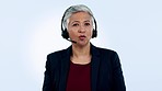 Call center, face or mature woman in communication, speaking or talking to help in customer service. Blue background, virtual assistant or senior sales agent with microphone in tech support in studio