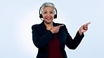 Call center, pointing or face of senior woman in communication or talking in customer service. Blue background, virtual assistant or mature sales agent with mockup space, contact or promo in studio