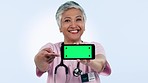 Doctor, phone green screen and woman presentation, talking of healthcare information or telehealth in studio. Face of medical nurse with mobile app mockup, video tracking marker and a blue background