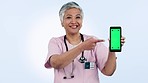 Nurse, phone green screen and woman presentation, talking of healthcare information or telehealth in studio. Face of medical doctor with mobile app mockup, video tracking marker and a blue background